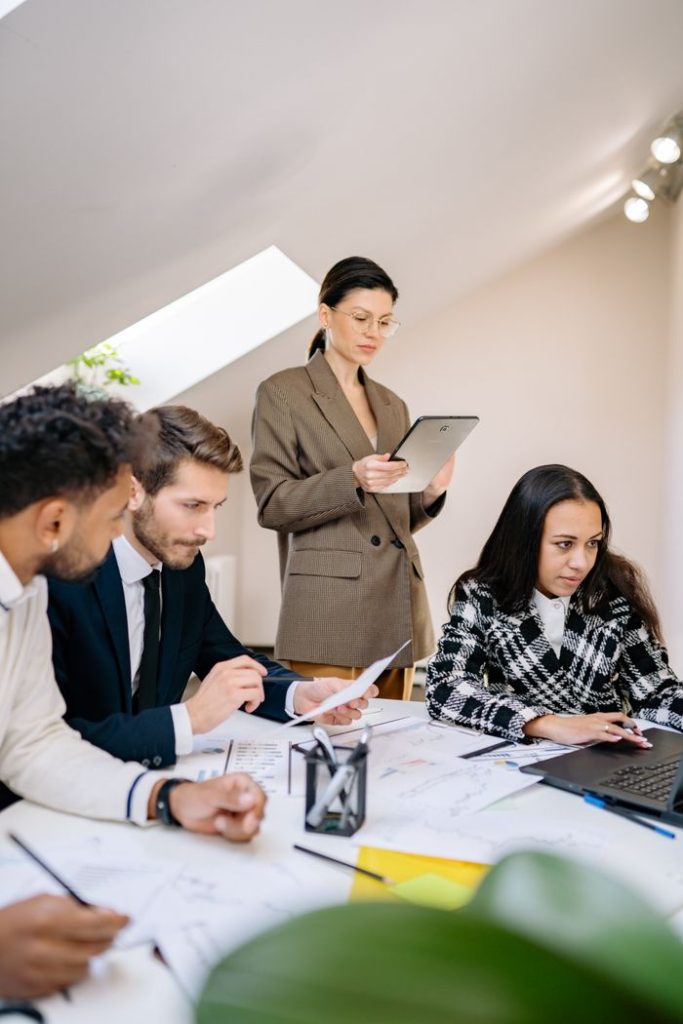 A diverse team working together in a bright office space, collaborating on a project.